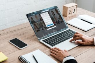 KYIV, UKRAINE – JULY 23, 2019: cropped view of woman using laptop with linkedin website near