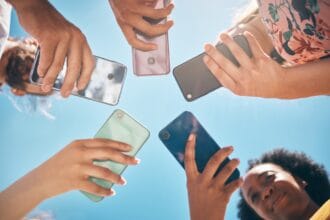 Phone circle, hands of people and low angle, communication or text. Blue sky, mobile and friends on